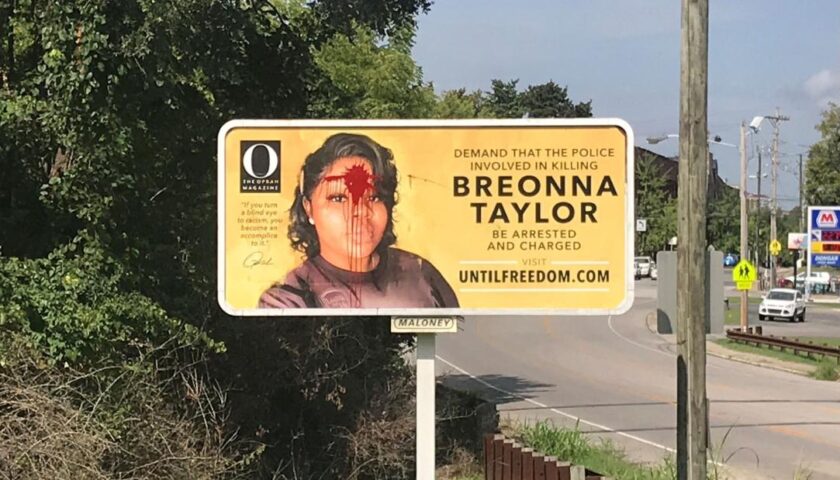 Red paint splatters Breonna Taylor billboard