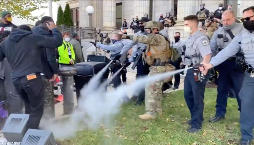 Police use pepper spray to break up a march to a polling place in North Carolina